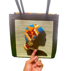 Woven straw Kente cloth medium handbag with woman silhouette and black leather